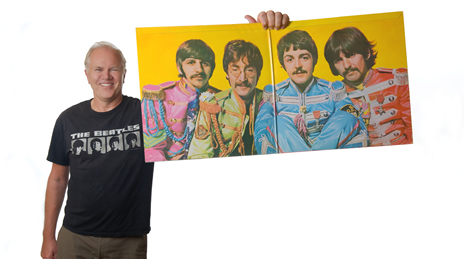 Steve holding a poster of The Beatles